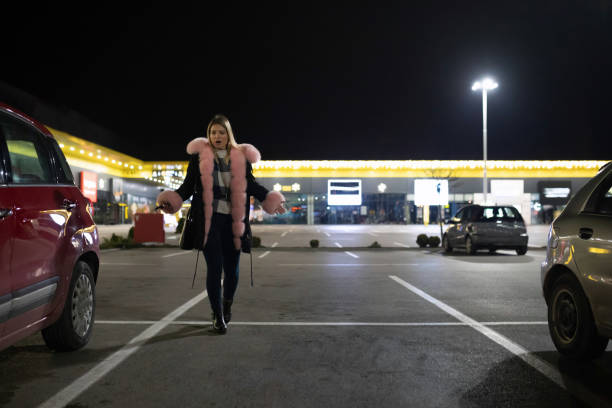 Woman in night parking lot